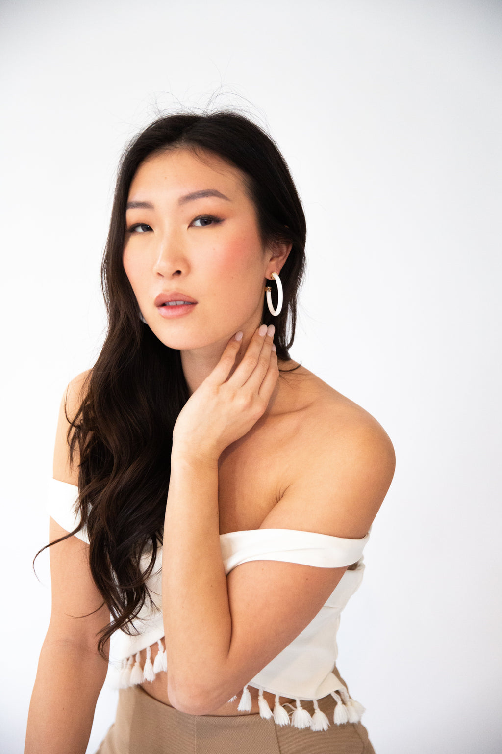 1.5-inch white hoop earrings by hoohoops styled on model
