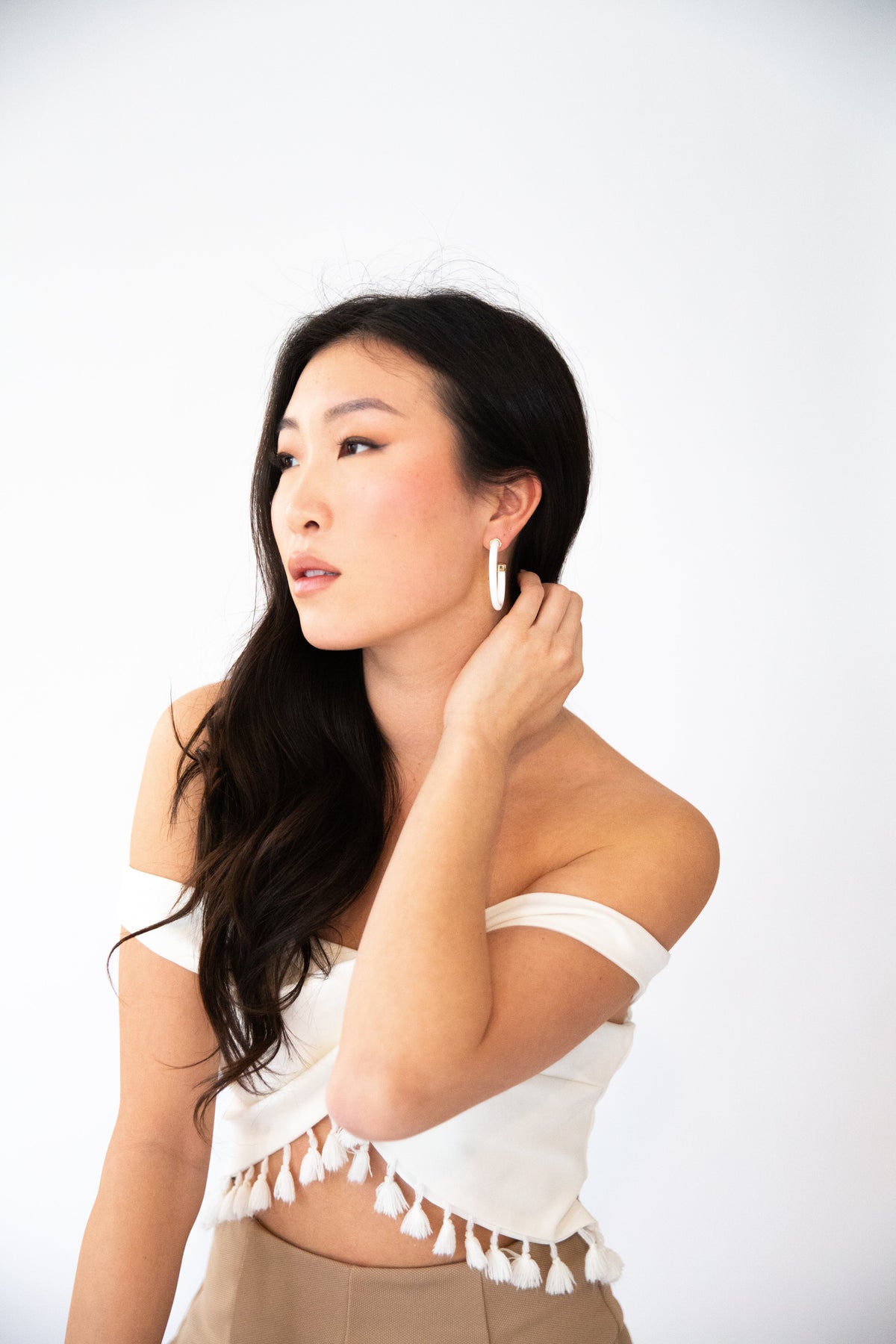 White 1.5-inch hoop earrings by hoohoops shown on model