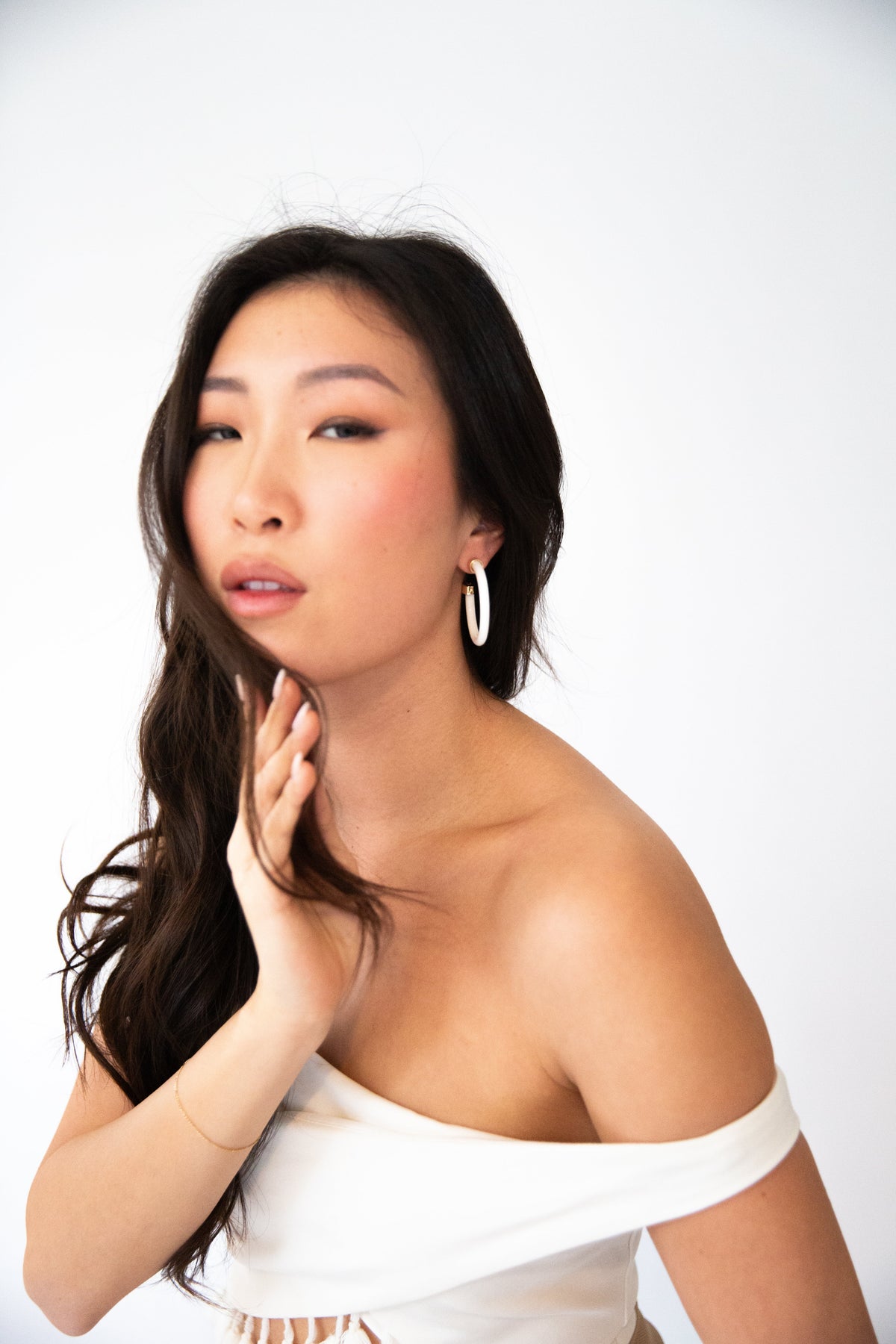 Lightweight white hoop earrings by hoohoops worn on model
