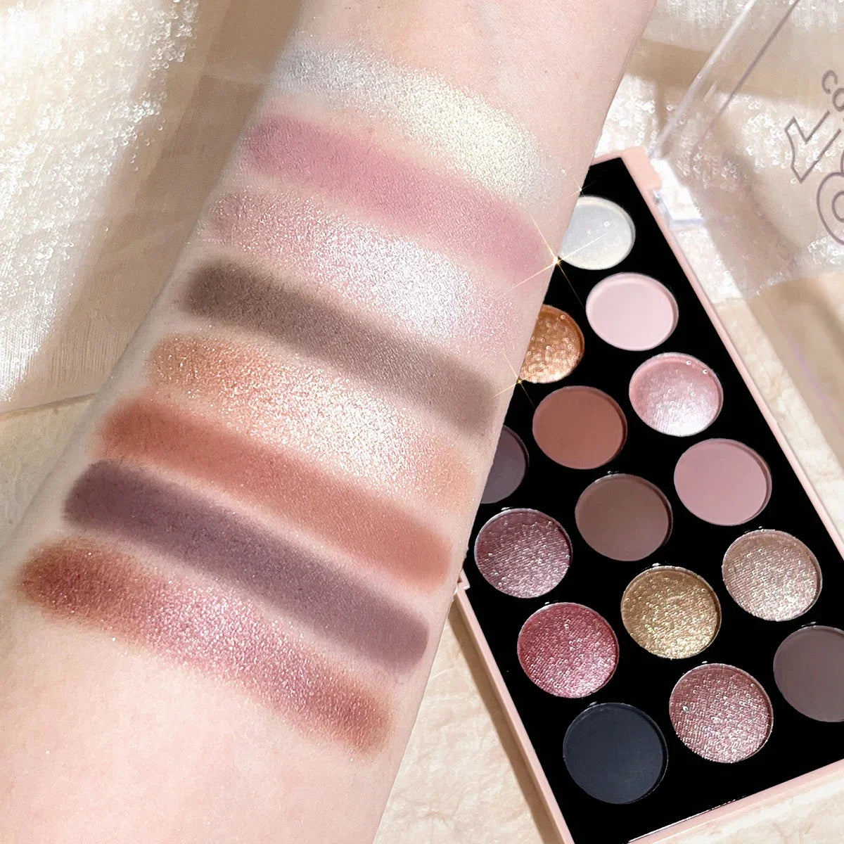 Close-up of multicolor eyeshadow pans in the 18-color palette