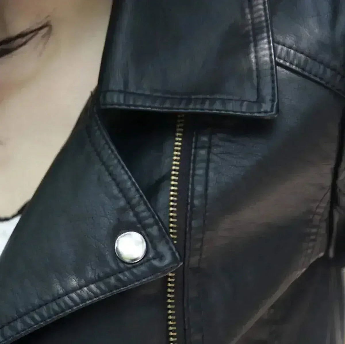 Cropped black vegan leather jacket detail view